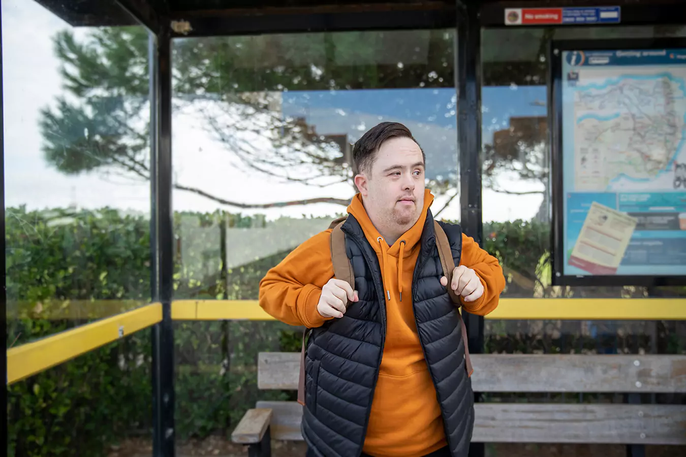 A disabled man standing at the bus stop