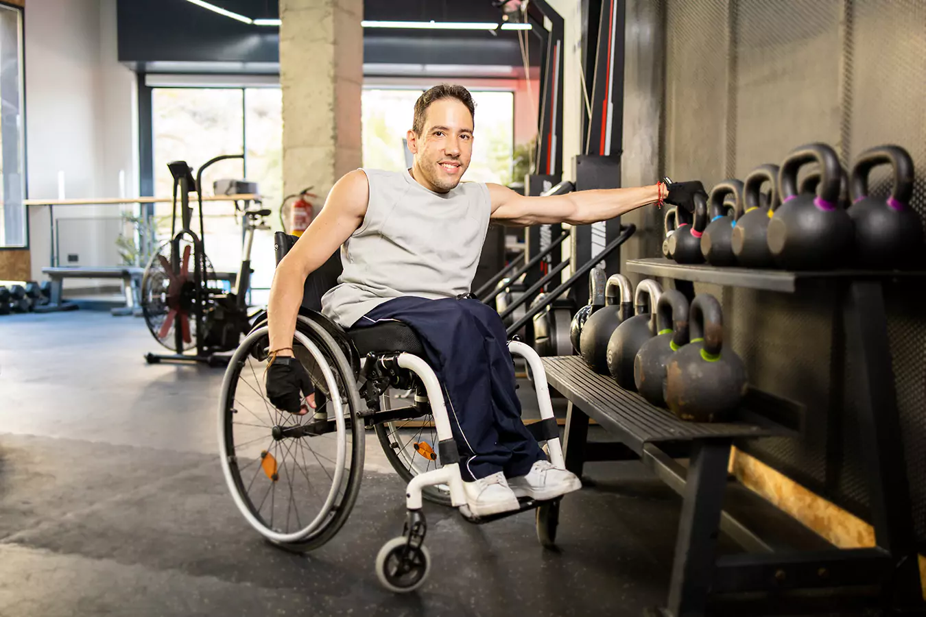 A disabled man in his wheelchair in the gym